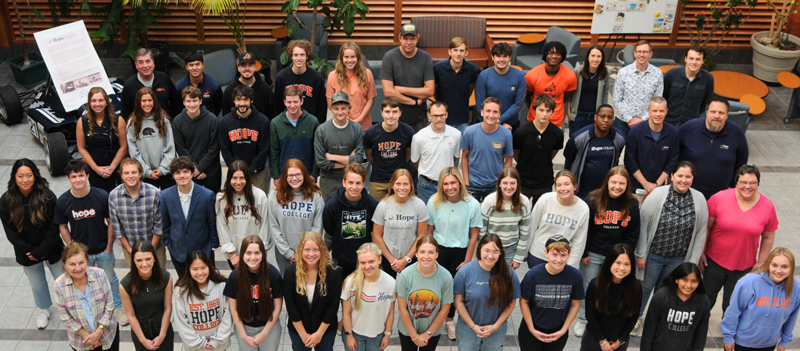 Chemistry students and faculty posing in a group in the A. Paul Schaap Science Center lobby