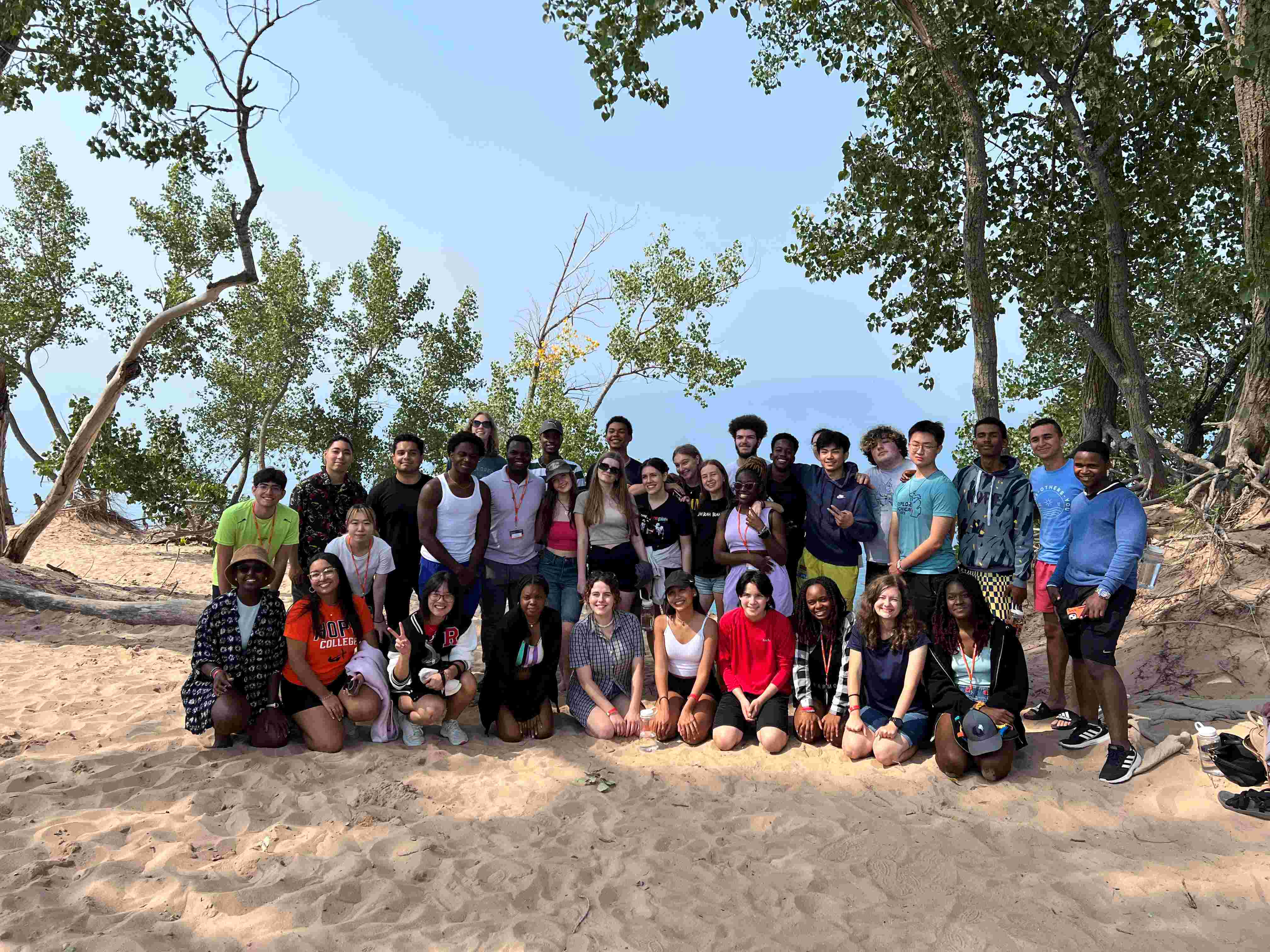 Group photo of international and third culture kid freshmen students at the Sleeping Bear Dunes overlooking Lake Michigan