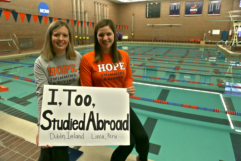 Two female students holding a sign