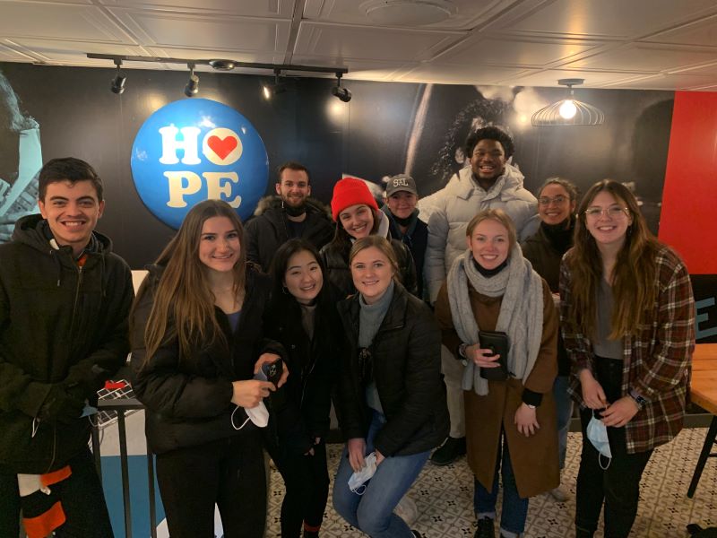 Washington Honors Semester students posing in front of a sign that says “Hope”