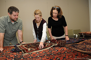 Charles Mason, Caleigh White '20 and Dr. Debra Swanson examing works from the KAM's "Once Were Nomads" exhibition