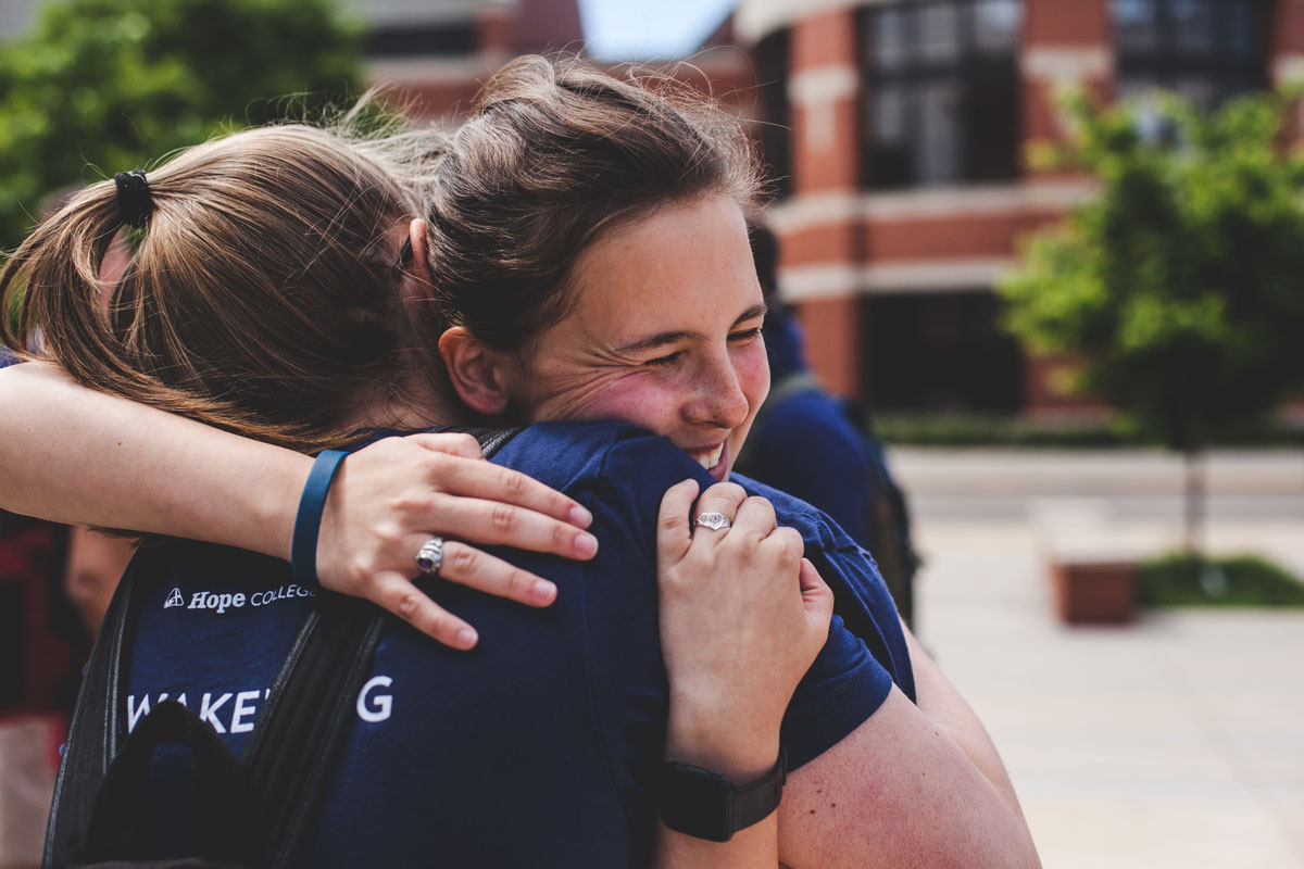 Two Awakening students hugging