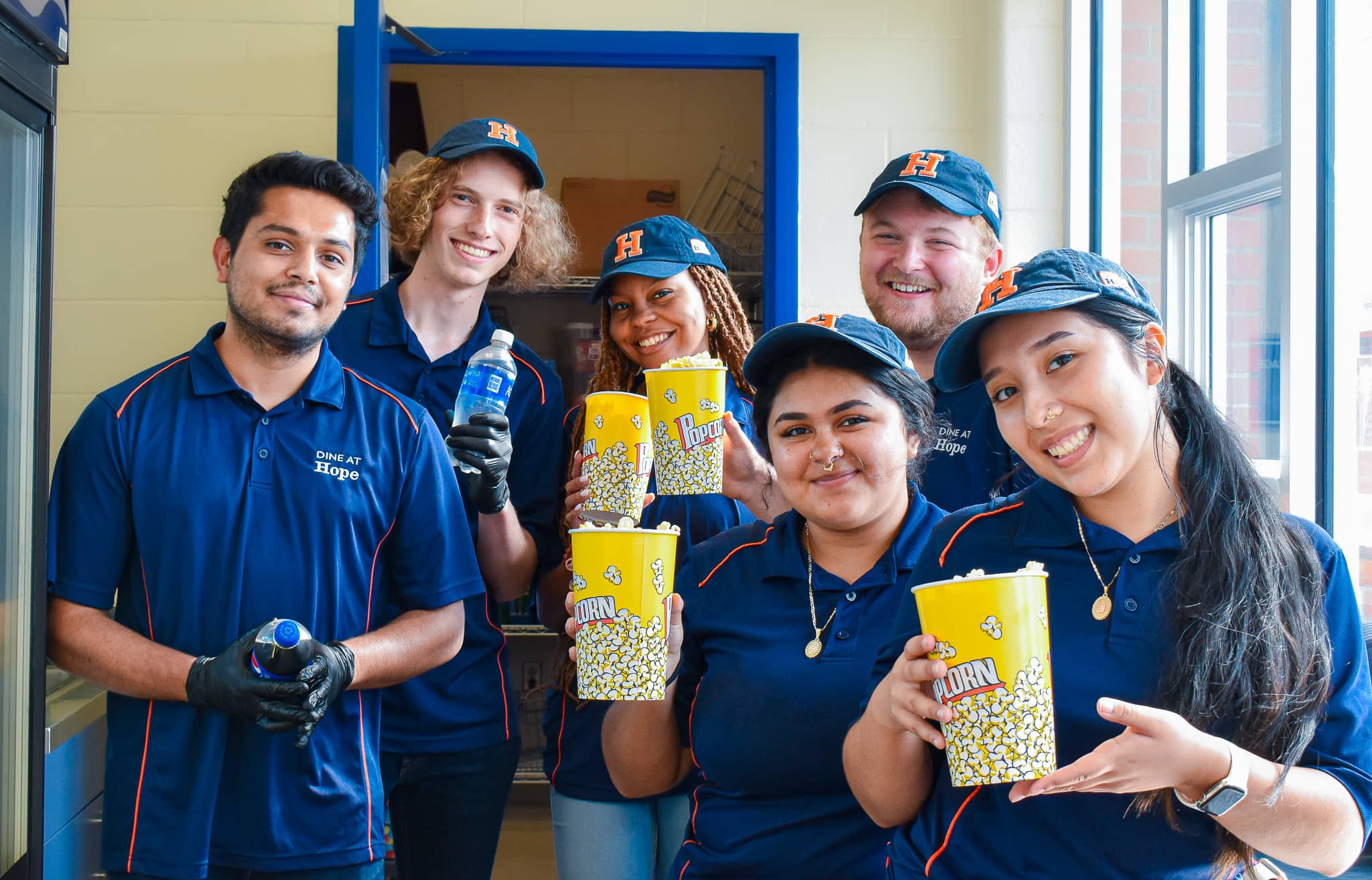 Student workers smiling with food