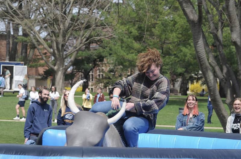 A student rides a mechanical bull at Hope’s Spring Fling