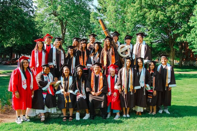 Upward Bound graduating class of 2024 in graduation robes and caps